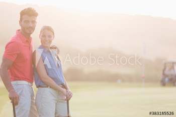 Portrait confident golfer couple on sunny golf course