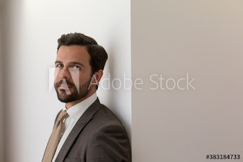 Portrait confident handsome corporate businessman in suit