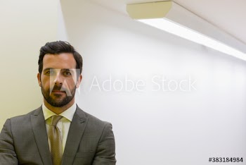 Portrait confident handsome corporate businessman in suit