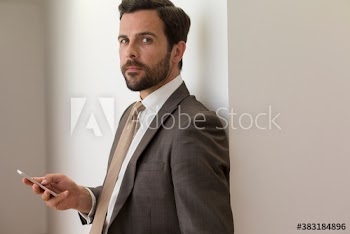 Portrait confident handsome corporate businessman with smart phone