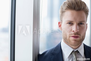Portrait confident handsome young businessman