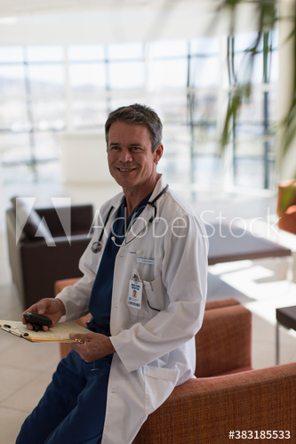 Portrait confident male doctor in hospital lobby