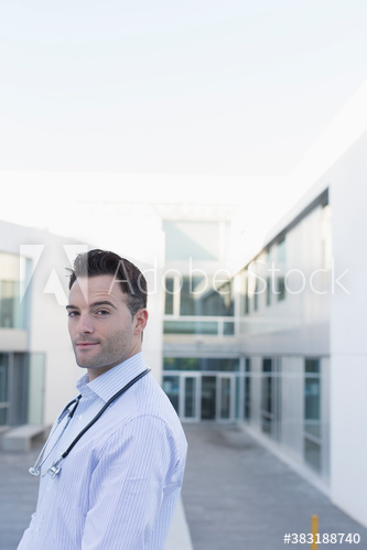 Portrait confident male doctor on hospital balcony