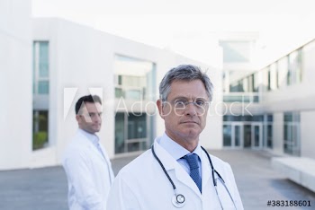 Portrait confident male doctors on hospital balcony