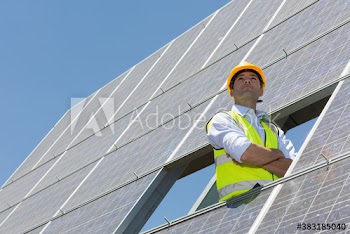 Portrait confident male engineer examining solar panels