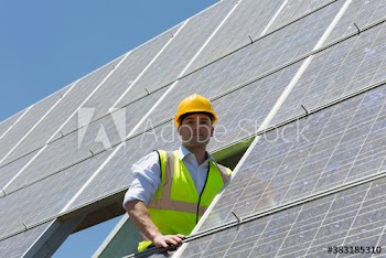 Portrait confident male engineer examining solar panels