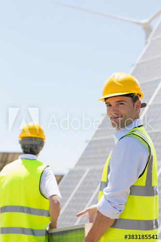 Portrait confident male engineer working on solar farm