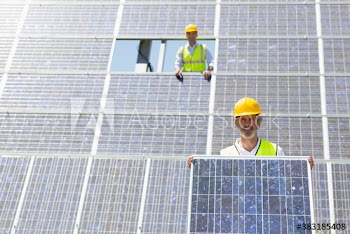 Portrait confident male engineers assembling solar panels