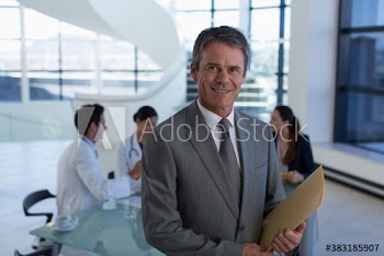 Portrait confident male hospital administrator in meeting