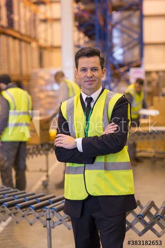 Portrait confident male manager in distribution warehouse