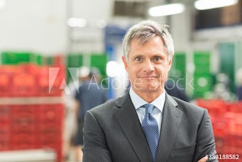 Portrait confident male manager in food processing plant