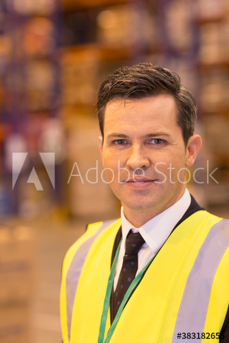 Portrait confident male manager in warehouse