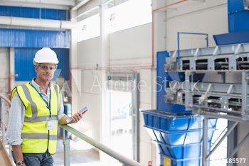 Portrait confident male manager with digital tablet in warehouse