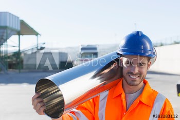 Portrait confident male worker carrying stainless steel canister