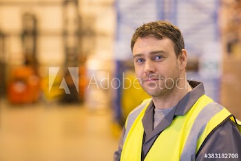 Portrait confident male worker in distribution warehouse