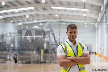 Portrait confident male worker on factory floor