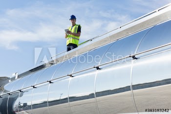 Portrait confident male worker on top of milk tanker