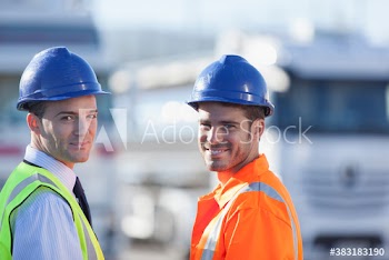 Portrait confident male workers in hard hats and reflective clothing