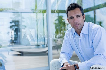 Portrait confident man sitting on patio