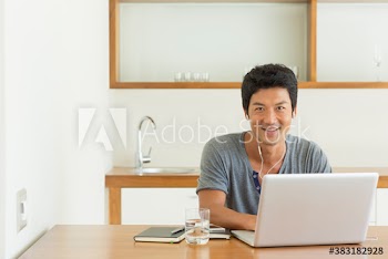 Portrait confident man with laptop working from home