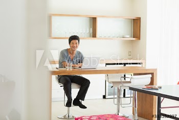 Portrait confident man with laptop working from home