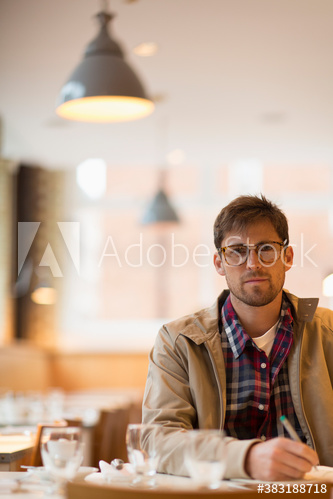 Portrait confident man working in cafe