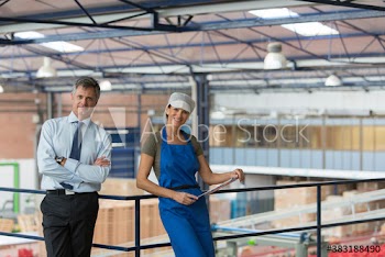 Portrait confident manager and worker in food processing plant