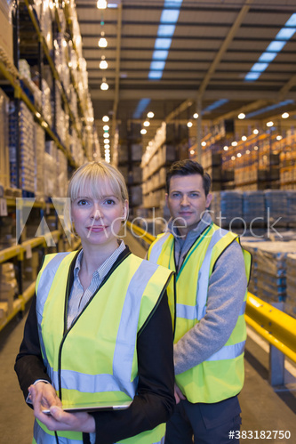 Portrait confident managers in distribution warehouse