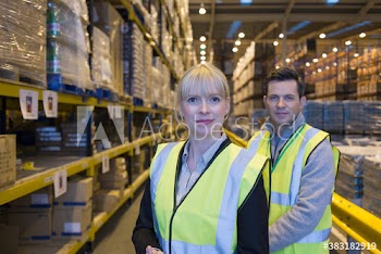 Portrait confident managers in distribution warehouse