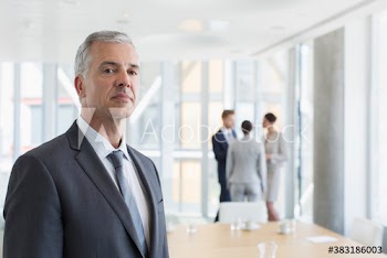 Portrait confident mature corporate businessman in office