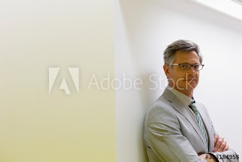 Portrait confident mature corporate businessman in suit