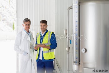 Portrait confident scientist and worker in factory