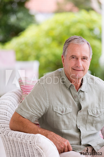 Portrait confident senior man on patio