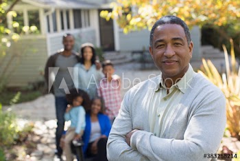 Portrait confident senior man with family on autumn patio