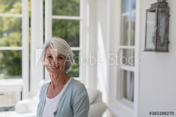 Portrait confident senior woman in sunroom