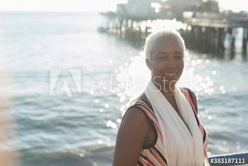 Portrait confident senior woman on sunny ocean beach