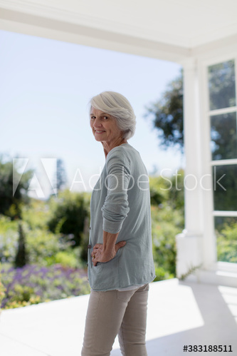 Portrait confident senior woman on sunny patio