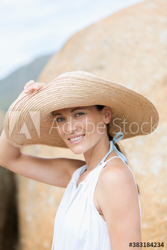 Portrait confident woman in sun hat