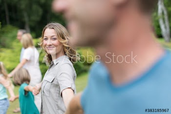 Portrait confident woman with family in backyard