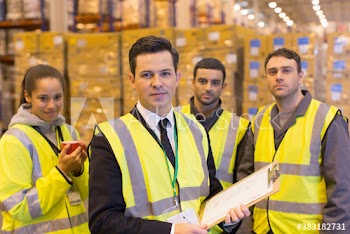 Portrait confident workers and manager in distribution warehouse
