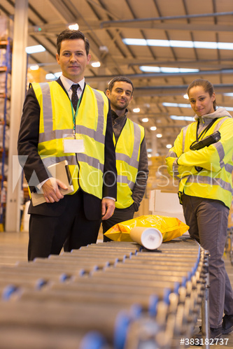 Portrait confident workers in distribution warehouse