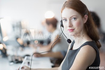 Portrait confident young businesswoman with headset in office