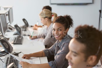 Portrait confident young businesswoman working in call center