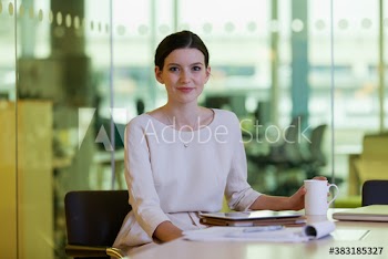 Portrait confident young corporate businesswoman in conference room