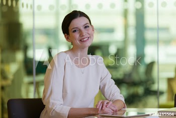 Portrait confident young corporate businesswoman in office