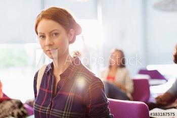 Portrait confident young female college student
