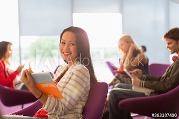 Portrait confident young female college student in student lounge