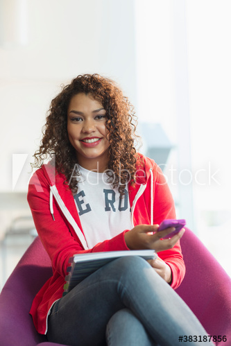 Portrait confident young female college student using smart phone