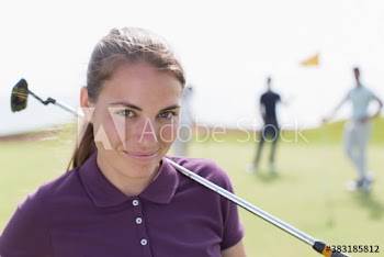 Portrait confident young female golfer on golf course