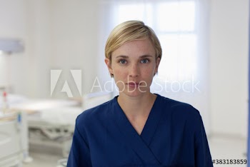 Portrait confident young female nurse in hospital